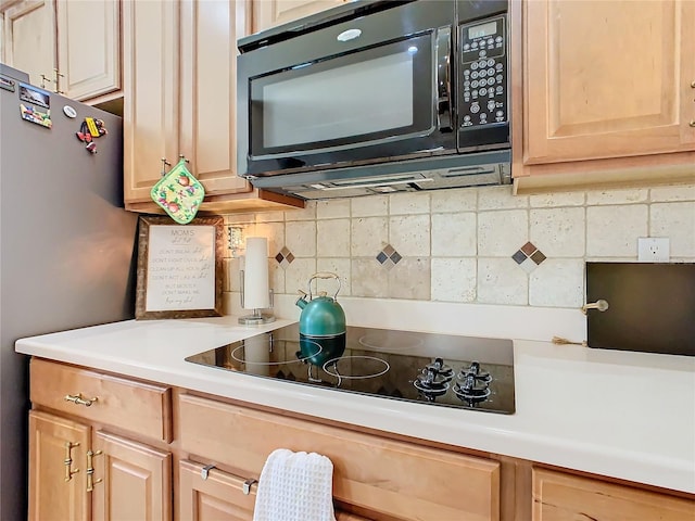 kitchen featuring tasteful backsplash, black appliances, and light brown cabinetry