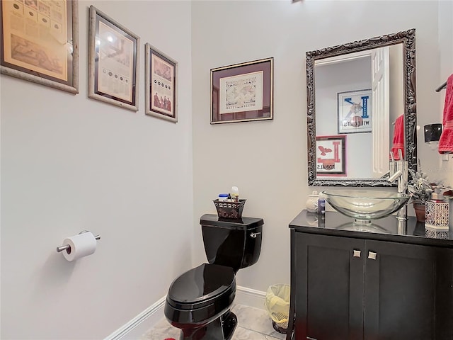 bathroom featuring vanity, tile patterned flooring, and toilet