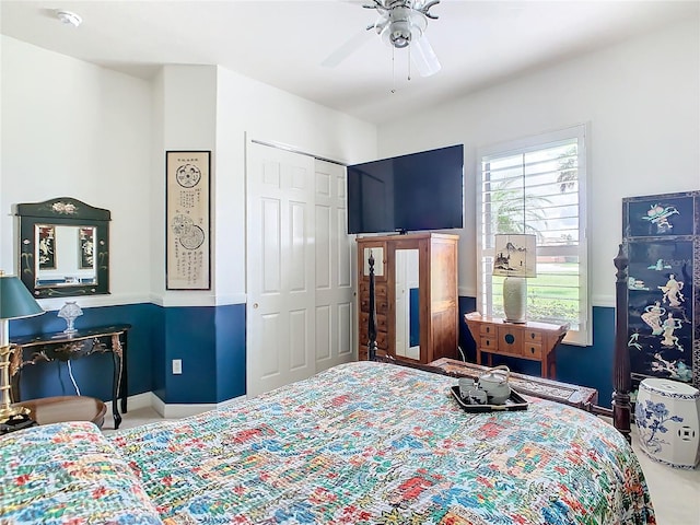 carpeted bedroom featuring ceiling fan and a closet