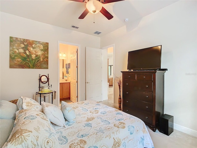 carpeted bedroom with connected bathroom and ceiling fan