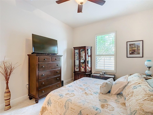 bedroom with light carpet and ceiling fan