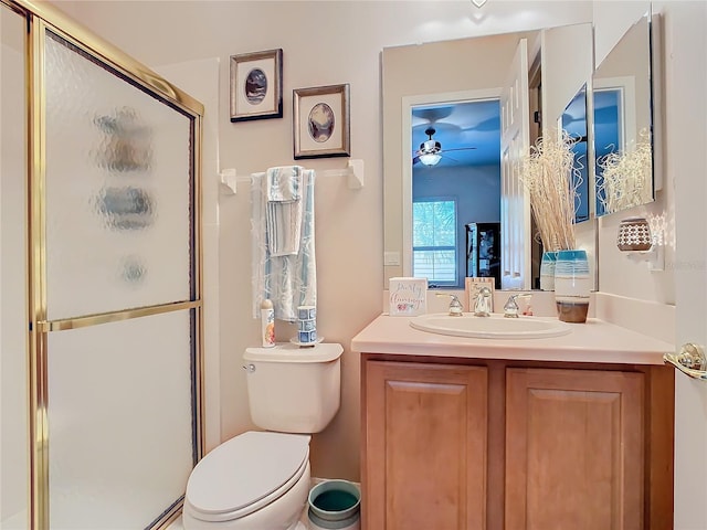 bathroom with a shower with door, vanity, and toilet