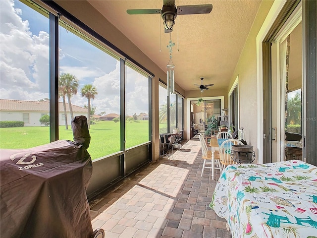 sunroom / solarium with ceiling fan