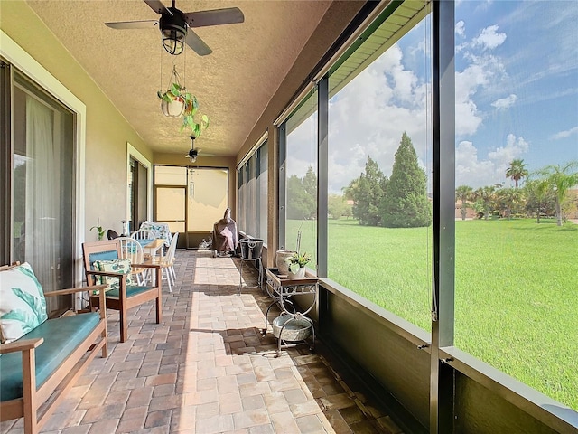 sunroom featuring ceiling fan