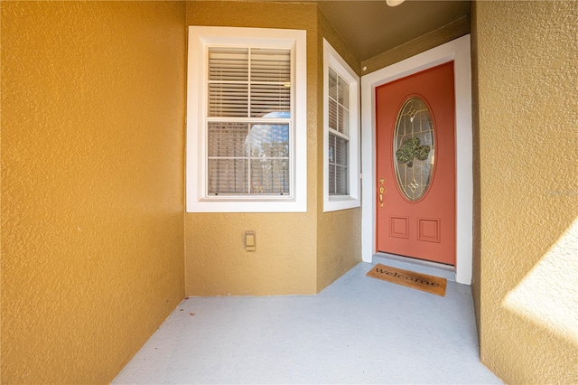 view of exterior entry with a porch