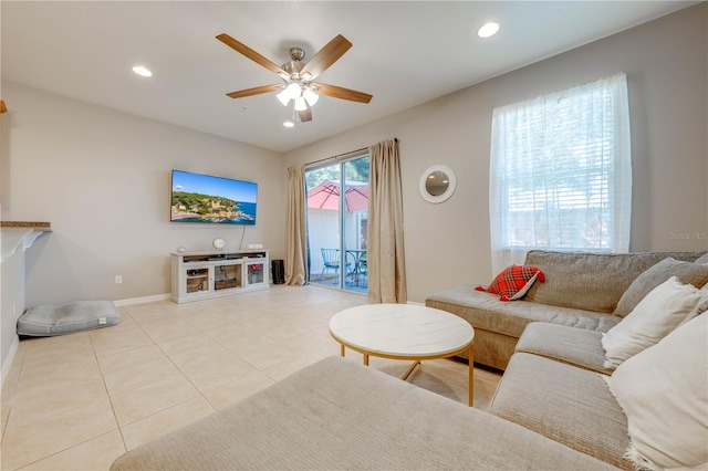 living room featuring ceiling fan and light tile patterned floors