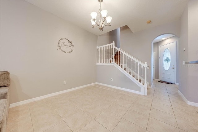 foyer entrance featuring an inviting chandelier and light tile patterned floors