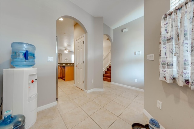 interior space featuring tile patterned flooring and ceiling fan