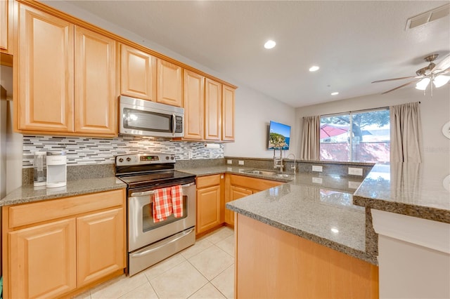 kitchen with appliances with stainless steel finishes, sink, backsplash, light tile patterned floors, and ceiling fan