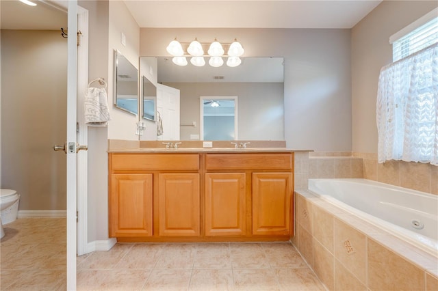 bathroom featuring double vanity, tiled tub, tile patterned flooring, and toilet