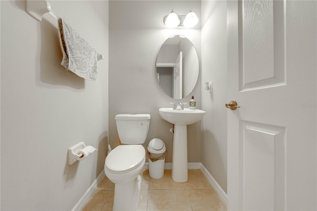 bathroom with toilet and tile patterned floors