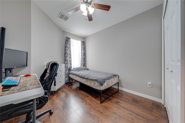 bedroom featuring a closet, lofted ceiling, ceiling fan, and dark hardwood / wood-style floors