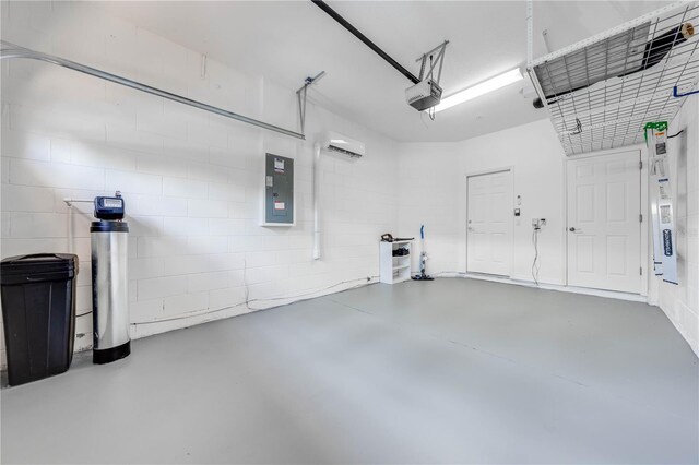 garage featuring a wall unit AC, a garage door opener, and electric panel