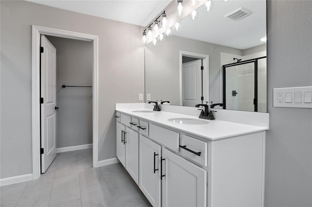 bathroom with walk in shower and vanity