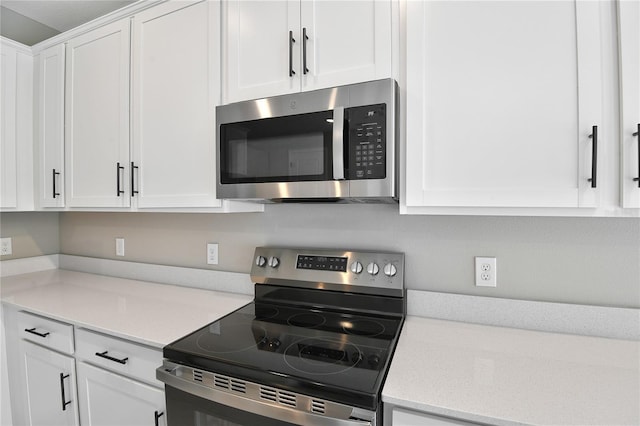 kitchen with stainless steel appliances and white cabinets