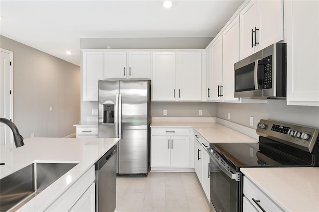 kitchen with stainless steel appliances, sink, and white cabinets