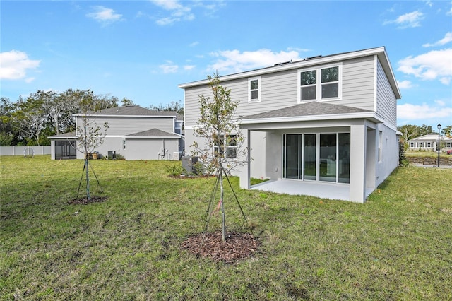 back of property with a yard and a sunroom