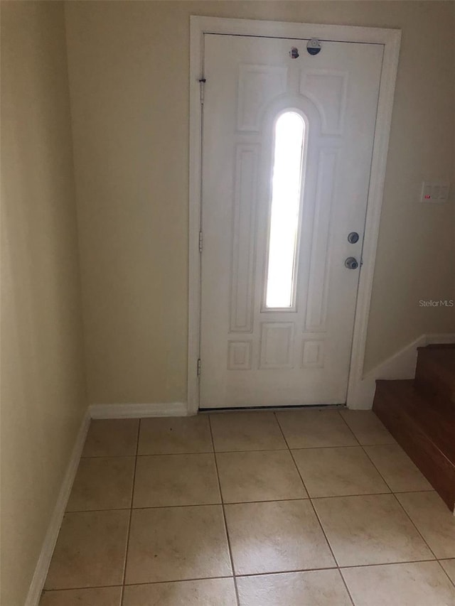 foyer entrance featuring light tile patterned flooring