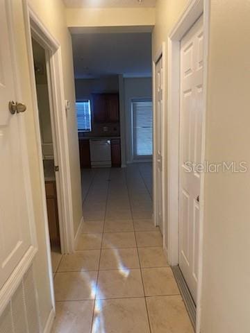 hall featuring light tile patterned flooring