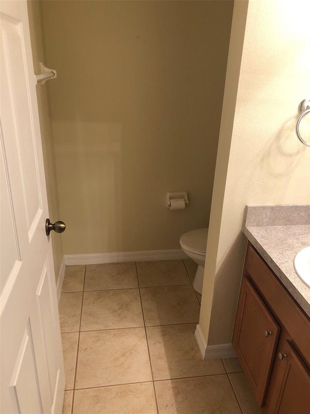 bathroom with vanity, toilet, and tile patterned flooring