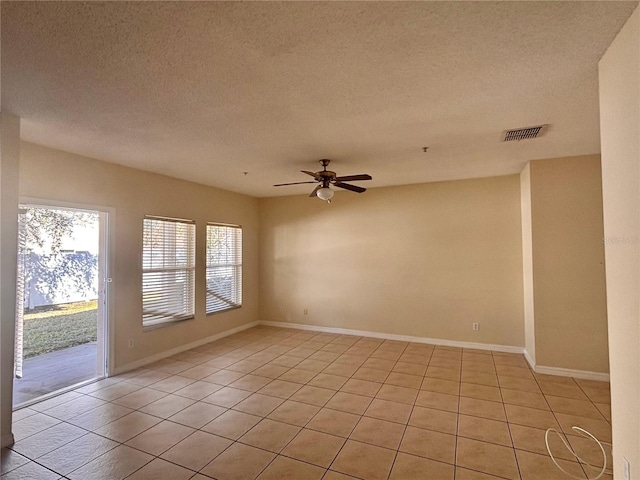 spare room featuring light tile patterned floors, a textured ceiling, and ceiling fan