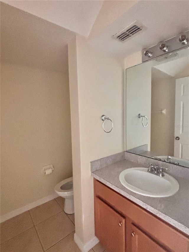 bathroom featuring tile patterned floors, toilet, and vanity