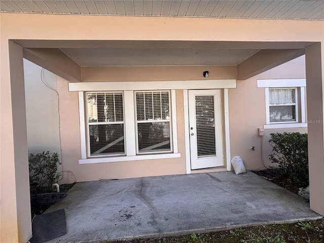 entrance to property featuring a patio area