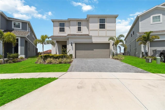 view of front facade featuring a garage and a front lawn