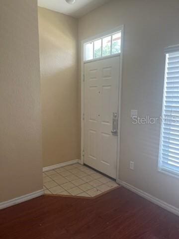 entryway featuring light wood-type flooring and baseboards