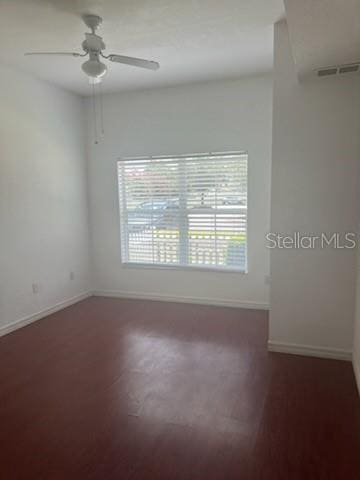 spare room featuring visible vents, ceiling fan, and baseboards