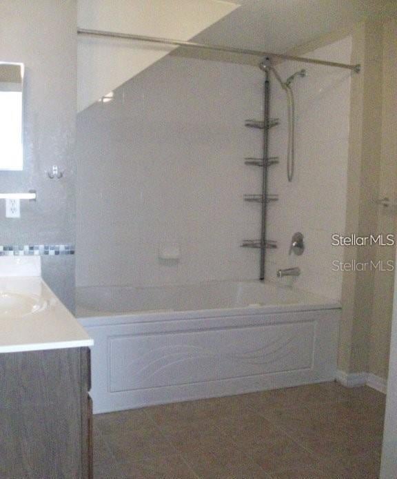 bathroom featuring vanity, tile patterned flooring, and bathtub / shower combination