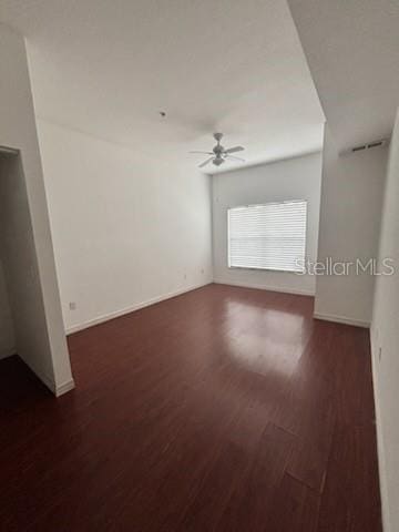 unfurnished room with dark hardwood / wood-style flooring and ceiling fan