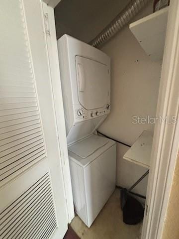 laundry room with stacked washing maching and dryer