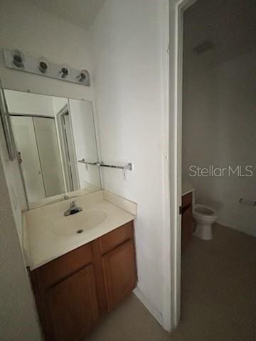 bathroom with toilet and vanity