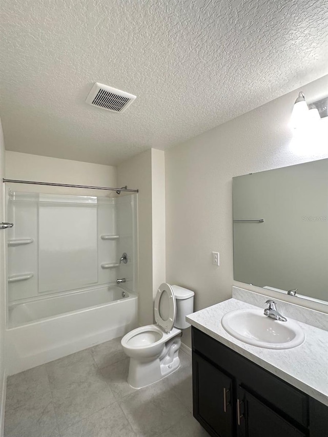 full bathroom with a textured ceiling, washtub / shower combination, toilet, vanity, and tile patterned floors