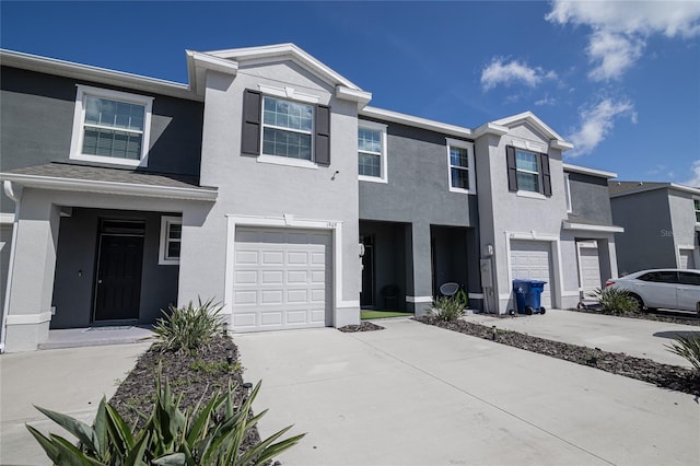 townhome / multi-family property featuring a garage