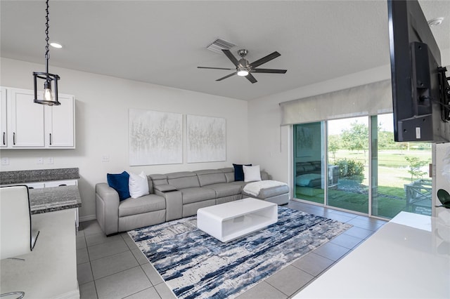 living room featuring tile patterned floors and ceiling fan