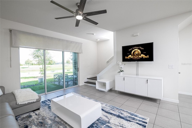 tiled living room featuring ceiling fan