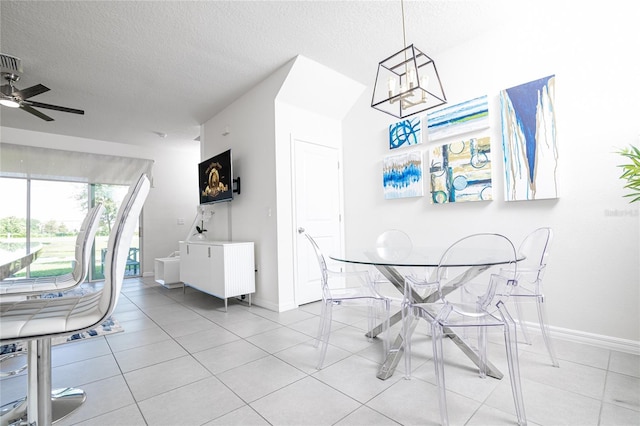 dining room with a textured ceiling, light tile patterned floors, and ceiling fan