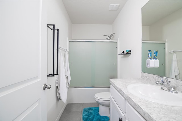 full bathroom featuring toilet, tile patterned floors, shower / bath combination with glass door, and vanity