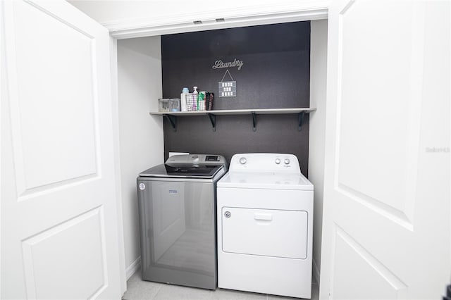 laundry room with light tile patterned flooring and independent washer and dryer