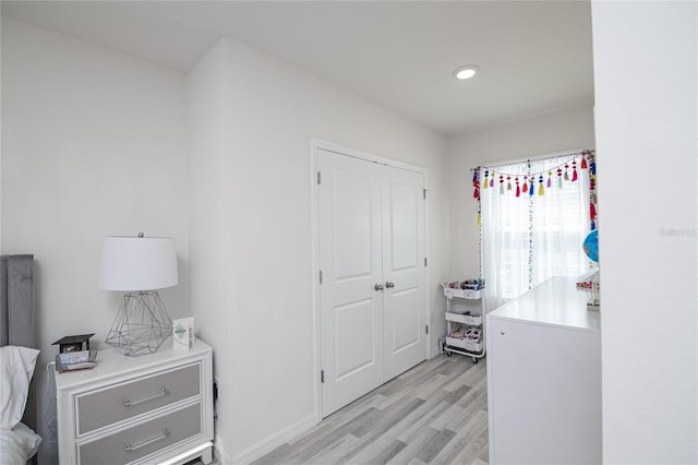 bedroom with a closet and light hardwood / wood-style floors