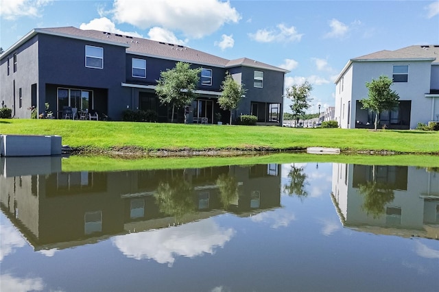 exterior space with a water view and a yard