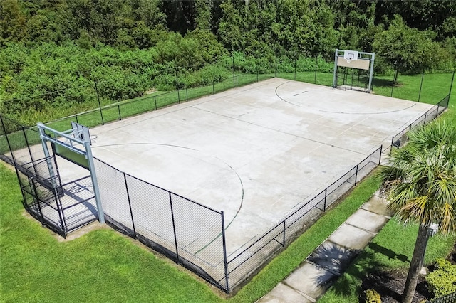 view of sport court with a lawn