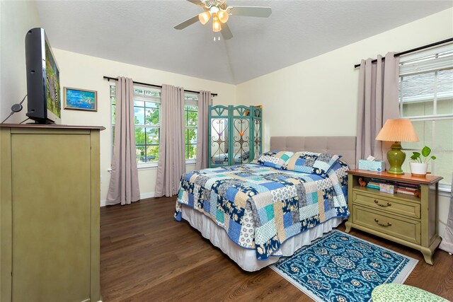 bedroom with ceiling fan, lofted ceiling, and hardwood / wood-style floors