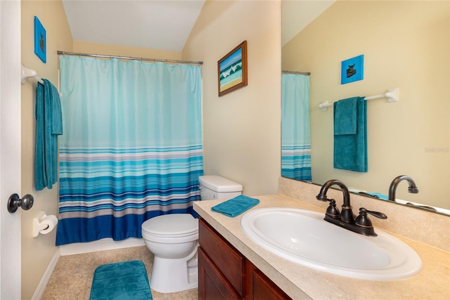 bathroom featuring lofted ceiling, vanity, and toilet