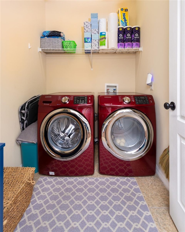 laundry room featuring washer and clothes dryer and tile patterned flooring