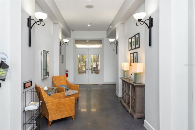 corridor with concrete flooring and french doors