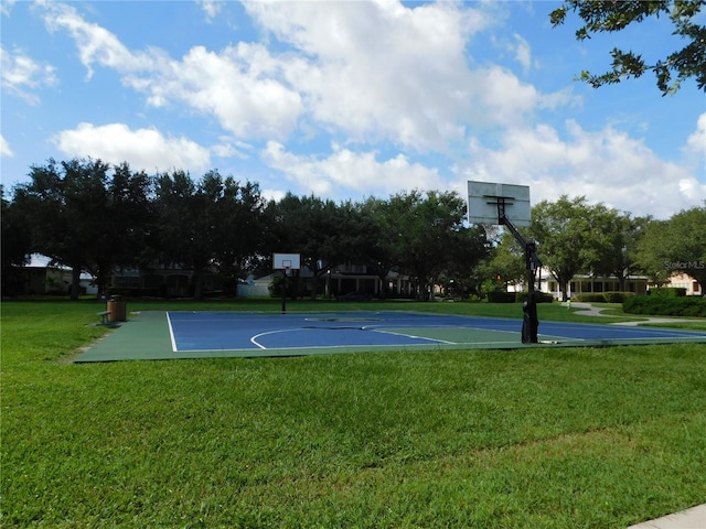 view of basketball court with a lawn