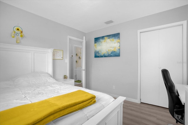 bedroom featuring a closet and wood-type flooring